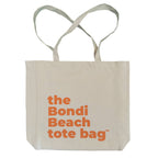 Beige tote bag with 'the Bondi Beach tote bag' text in orange on a white background